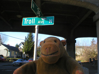 Mr Monkey beside the Troll Aveunue street sign