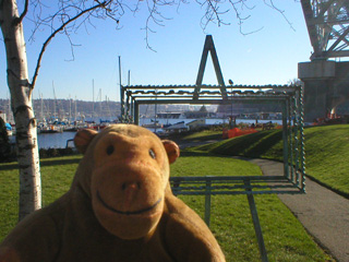 Mr Monkey looking at an empty picture frame sculpture