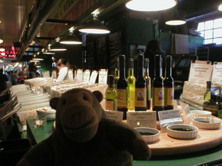 Mr Monkey looking at a stall selling balsamic vinegar and pasta