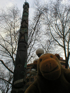 Mr Monkey looking at the Pioneer Place totem pole