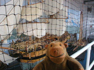 Mr Monkey examining an model of HMS Discovery