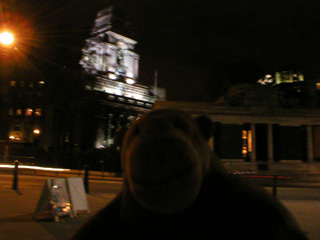 Mr Monkey looking at the floodlit old Port of London Authority building