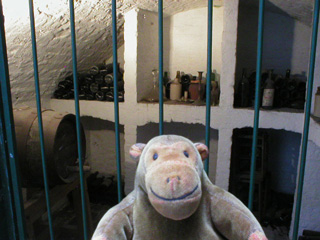 Mr Monkey looking at Dickens wine cellar