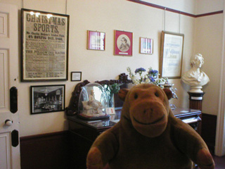 Mr Monkey looking at Charles Dickens's sideboard
