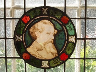 Charles Dickens on a glass roundel in the dining room window