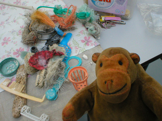 Mr Monkey looking at the found objects used to make patterns on the pins