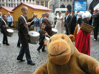 Mr Monkey watching a Belgian band march past the Hotel de Ville
