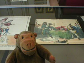 Mr Monkey looking at a case of political cartoons