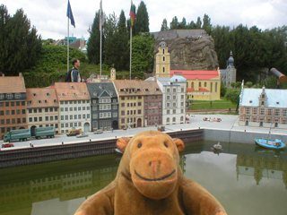 Mr Monkey looking at Nyhavn in Copenhagen, with other countries in the distance