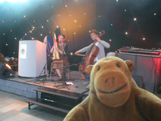 Mr Monkey watching Nancy Elisabeth playing a harp