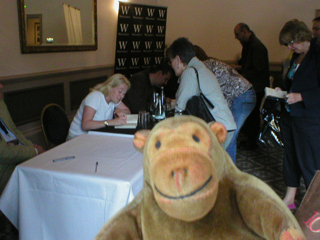 Mr Monkey watching Laura Wilson and Mark Billingham sign books