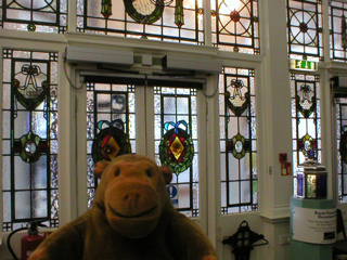 Mr Monkey looking at glass doors and wall of the Pump Rooms Annexe