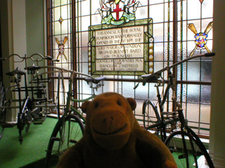 Mr Monkey looking at the dedicatory glass panel in the annexe