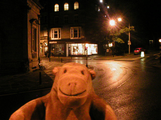 Mr Monkey walking past the Royal Pump Rooms at night