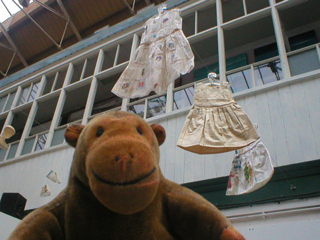 Mr Monkey looking up at Jennifer Collier's dresses