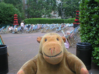 Mr Monkey watching people relaxing on deckchairs