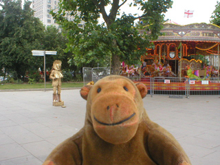 Mr Monkey watching a gold-painted man standing still