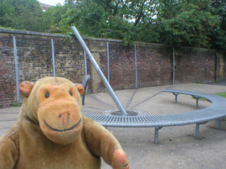 Mr Monkey looking at a giant sundial