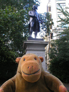 Mr Monkey looking at the statue of Robert Raikes