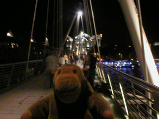 Mr Monkey looking at Charing Cross Station from across the Hungerford bridge