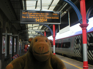 Mr Monkey getting off the train at Stockport