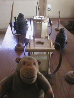 Mr Monkey looking at a table covered with lanterns