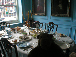 Mr Monkey looking at the the 18th century dining table