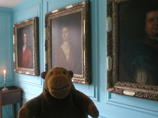 Mr Monkey looking at portraits in the dining room