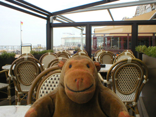 Mr Monkey in a cafe on the promenade