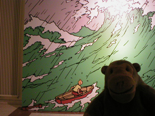 Mr Monkey looking at a giant picture of TinTin at sea