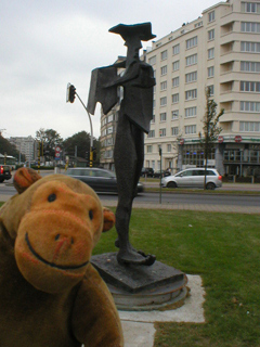 Mr Monkey looking at a gaunt statue