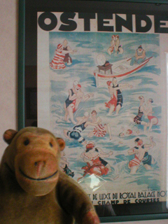 Mr Monkey looking at a poster in his hotel room