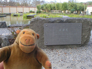 Mr Monkey looking at the dedication stone