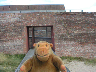 Mr Monkey crossing a bridge into Fort Napoleon