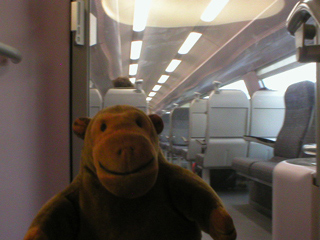 Mr Monkey aboard a train to Bruges