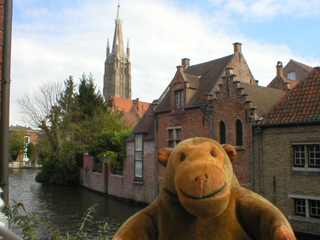 Mr Monkey looking at houses by a canal