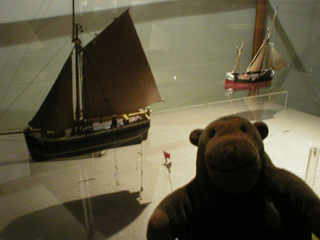 Mr Monkey looking at models of fishing techniques