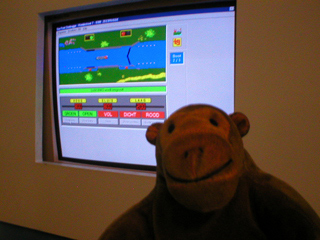 Mr Monkey looking at a computer simulation of the entrance lock to the canal