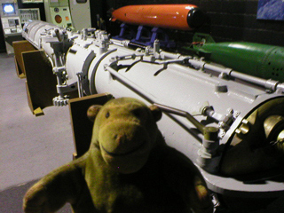 Mr Monkey looking at a German torpedo tube