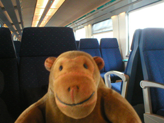 Mr Monkey aboard a train to Brussels