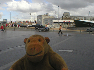 Mr Monkey watching people start to cross the lowered drawbridge