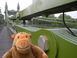 Mr Monkey beside the chains of the Hammersmith Bridge