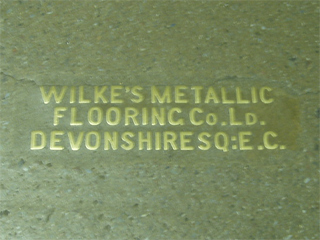 The makers name on the floor of the Kensington subway