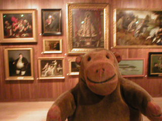 Mr Monkey examining paintings from the Wellcome Collection