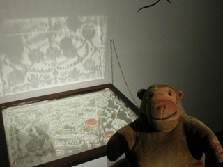 Mr Monkey looking at Pamela So's design on a mirror