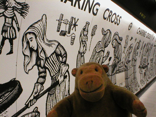 Mr Monkey looking at the decoration of Charing Cross underground station