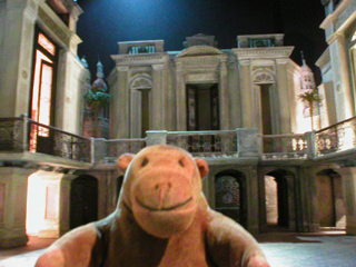 Mr Monkey looking at a model of the set for Evita