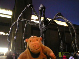 Mr Monkey looking at a giant spider outside Tate Modern