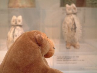 Mr Monkey looking at ancient Chinese owl-shaped bottles