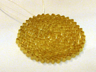 A intricate gold pendant by Noa Goren-Amir